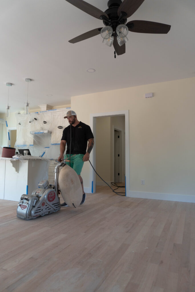 Guy sanding a wooden floors