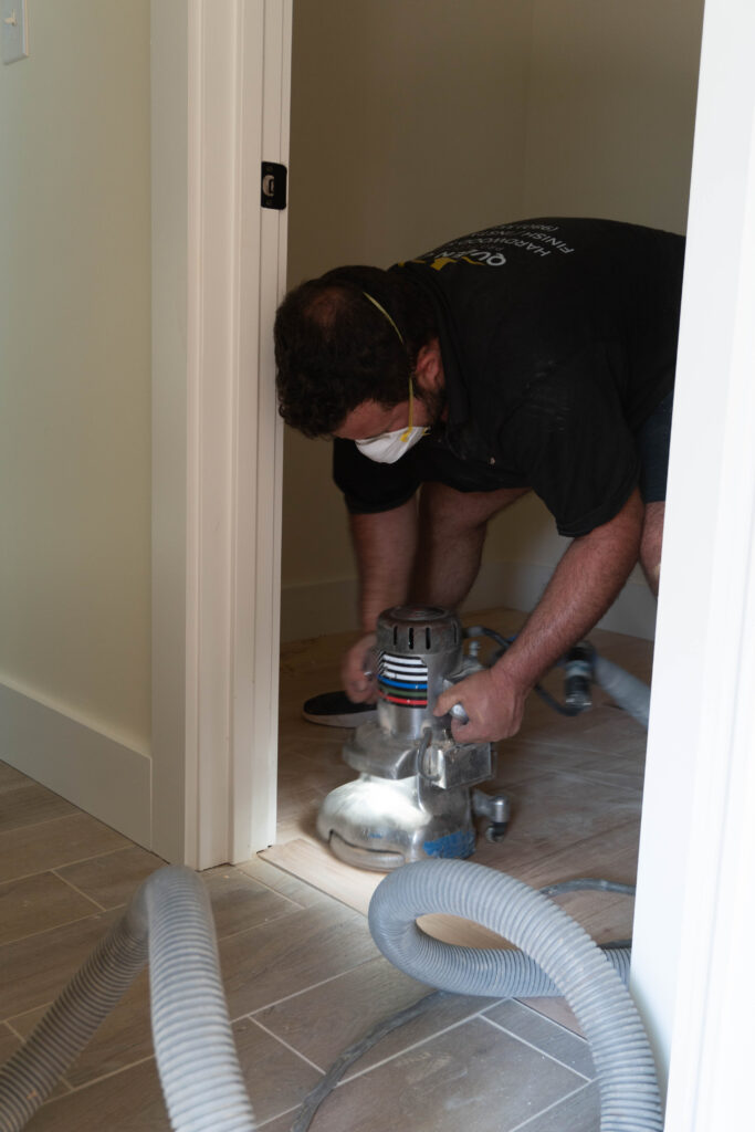 Guy sanding a wooden flooring